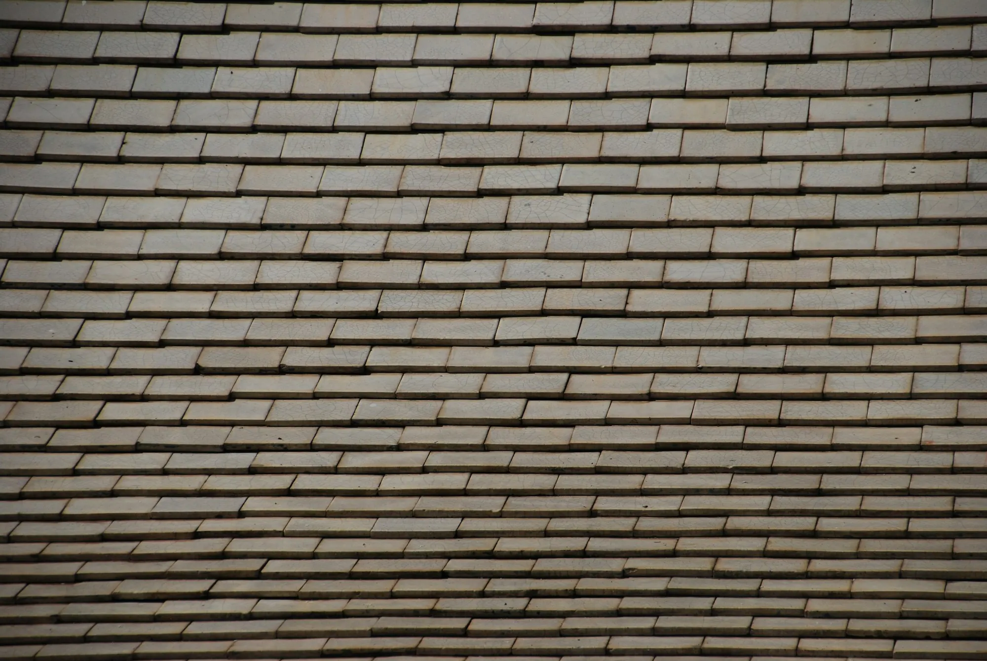 Low-angle close-up of rows of brown roof shingles